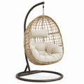 Poltrona sospesa in metallo e rattan con cuscino beige