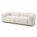 Divano in tessuto Bouclé beige con base in legno